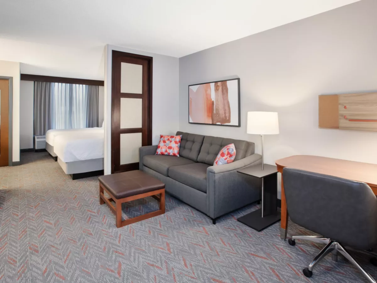 Candlewood Suites suite with sofa and desk